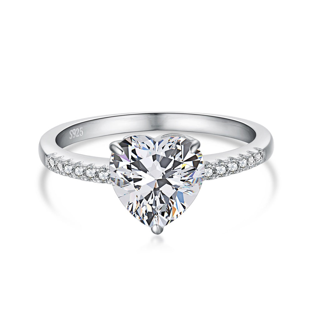A heart-shaped 5A CZ silver ring with small and big white stones on the band, displayed against a white background.