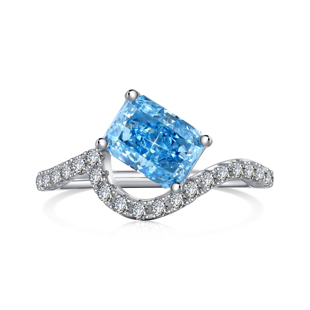 A sterling silver ring featuring a main stone, shaped as a rectangle and set with smaller round diamonds.