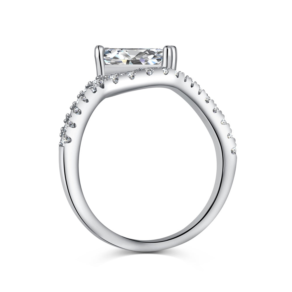 A sterling silver ring featuring a main stone (clear-color), shaped as a rectangle and set with smaller round diamonds.