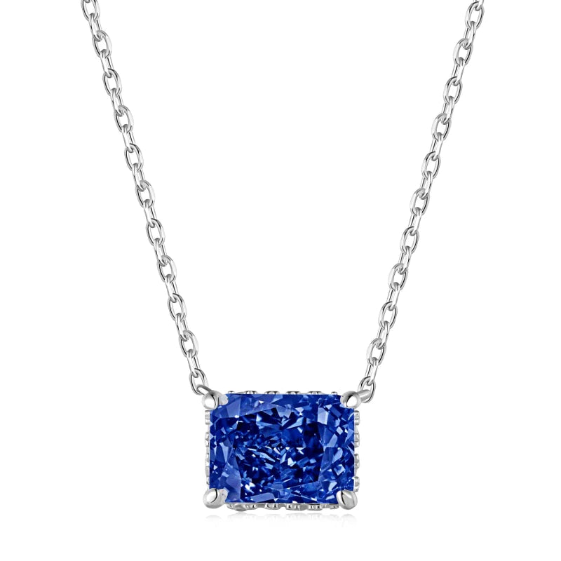 A rhodium plated necklace with a rectangle radiant cut 8A CZ main blue stone on a chain.