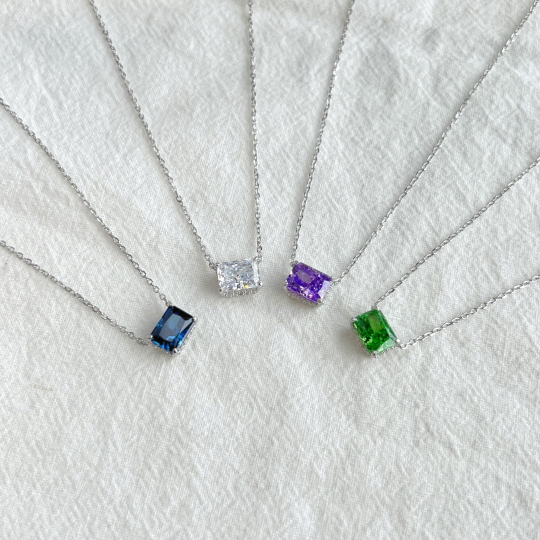 A collection of rhodium plated necklaces with rectangle radiant cut 8A CZ main stones on chain.