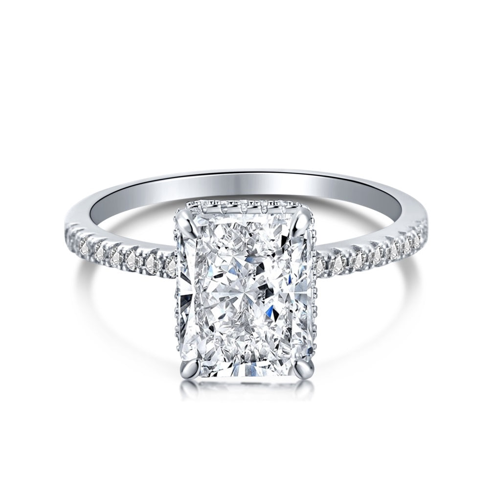 A silver-colored band engagement ring featuring a large rectangle-shaped central stone with smaller stones around it