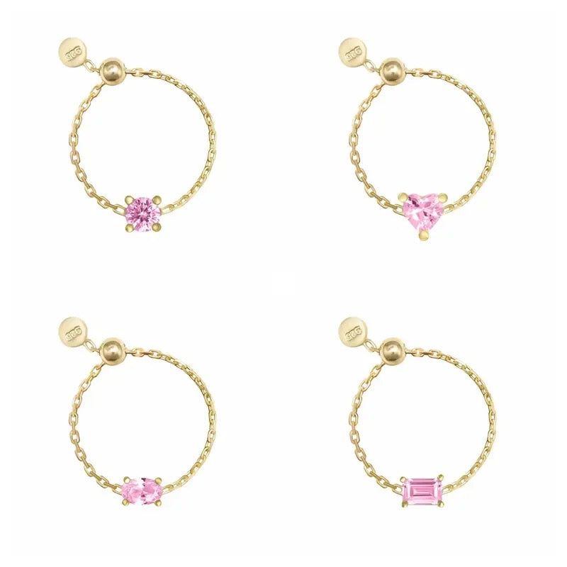 Four gold chain rings with different gemstone designs on a white background