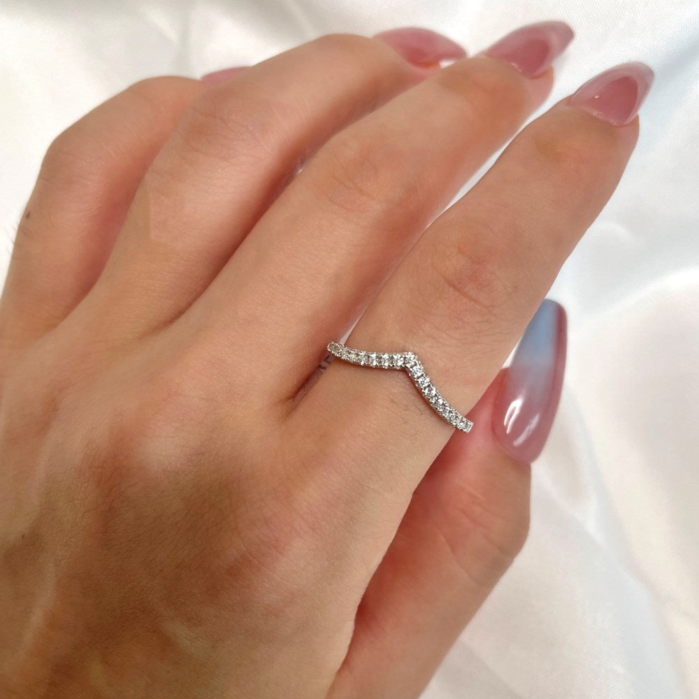 A silver ring featuring a single zircon stone with a wishbone design on the band.