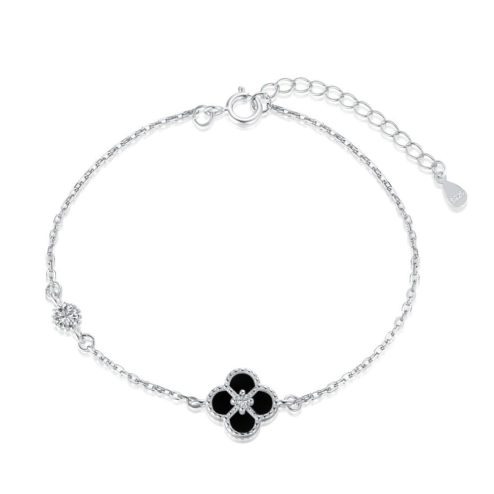 A sterling silver bracelet featuring a single flower-shaped pendant, with a chain-link design and a lobster clasp closure.