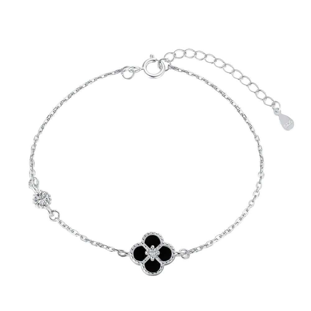 A sterling silver bracelet featuring a single flower-shaped pendant, with a chain-link design and a lobster clasp closure.