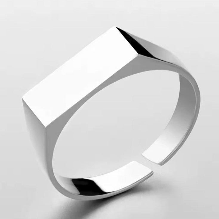 Silver engravable unisex ring with a unique design on a white background