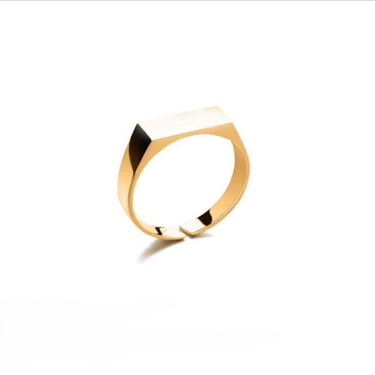 Gold engravable unisex ring with a unique design on a white background