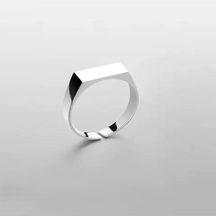 Silver engravable unisex ring with a unique design on a white background