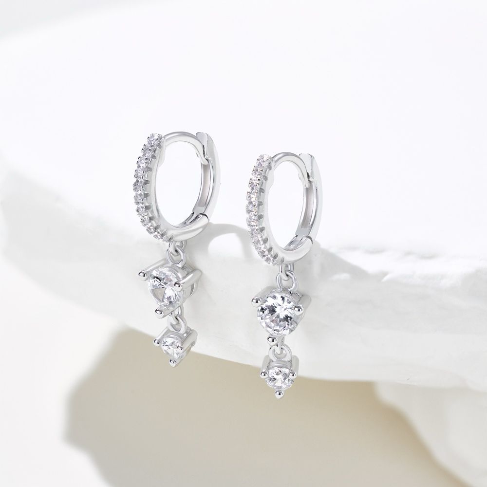 A pair of gold-plated silver hoop earrings with drop-shaped settings containing cubic zirconia stones.