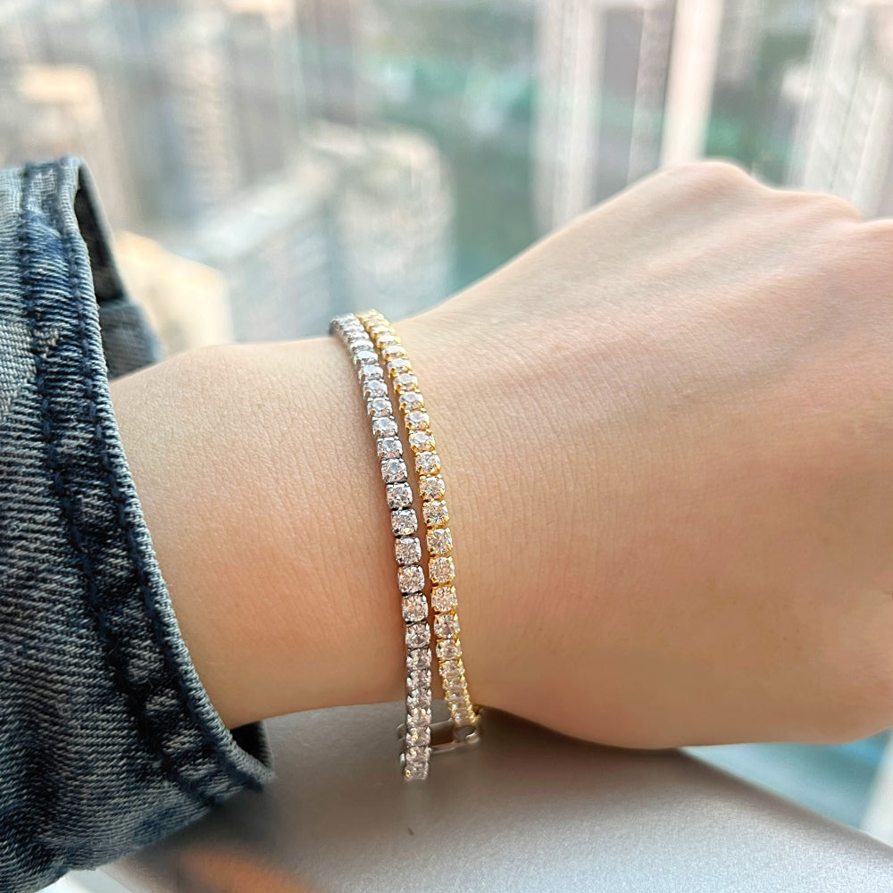 Two sterling silver tennis bracelets with gold/silver accents and cubic zirconia stones.