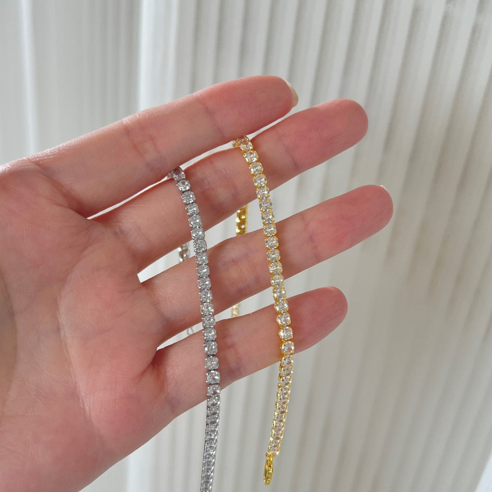 Sterling silver tennis bracelets with gold/silver accents and cubic zirconia stones, featuring a clasp closure.