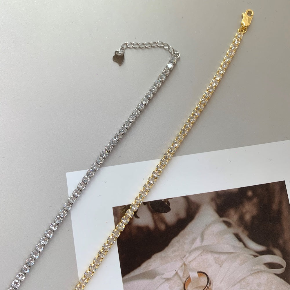 Two sterling silver tennis bracelets with gold/silver accents and cubic zirconia stones, featuring a clasp closure.