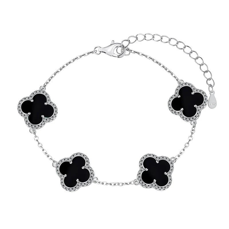 An elegant 925 sterling silver bracelet featuring a clover design with black shell accents on an adjustable chain.
