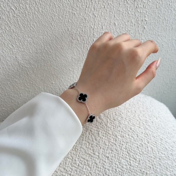 Elegant 925 sterling silver bracelet featuring clover design with black shell accents with an adjustable chain.