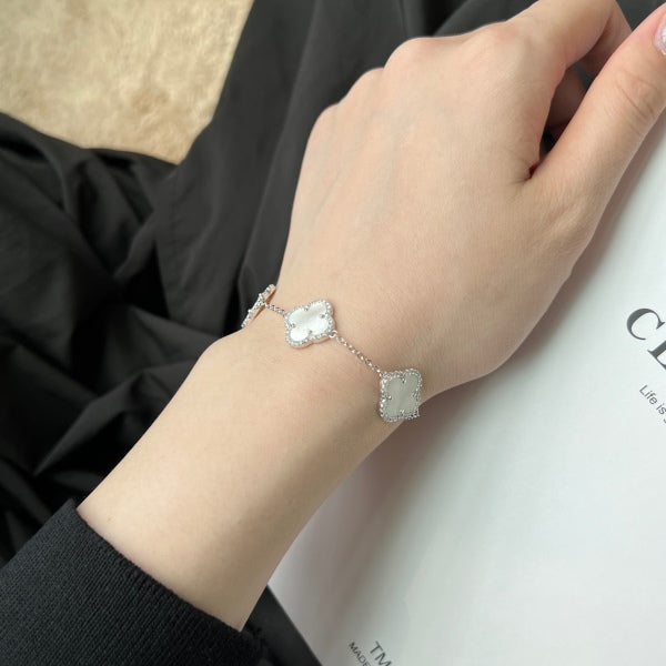 Elegant 925 sterling silver bracelet featuring clover design with white shell accents with an adjustable chain.