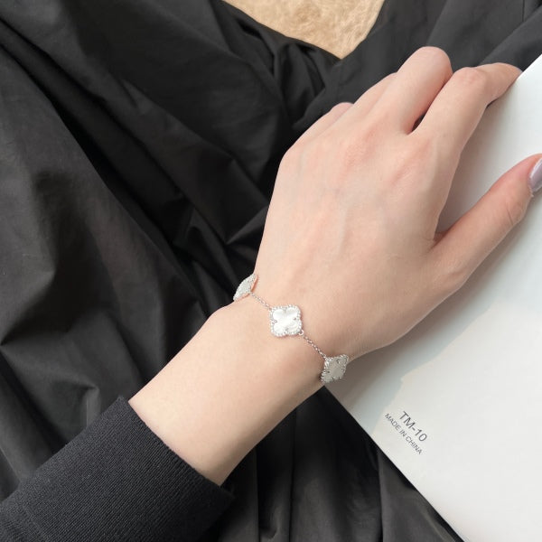 Elegant 925 sterling silver bracelet featuring clover design with white shell accents with an adjustable chain.