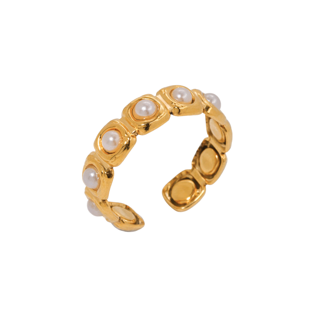 Gold ring with pearl-like stones on a white background