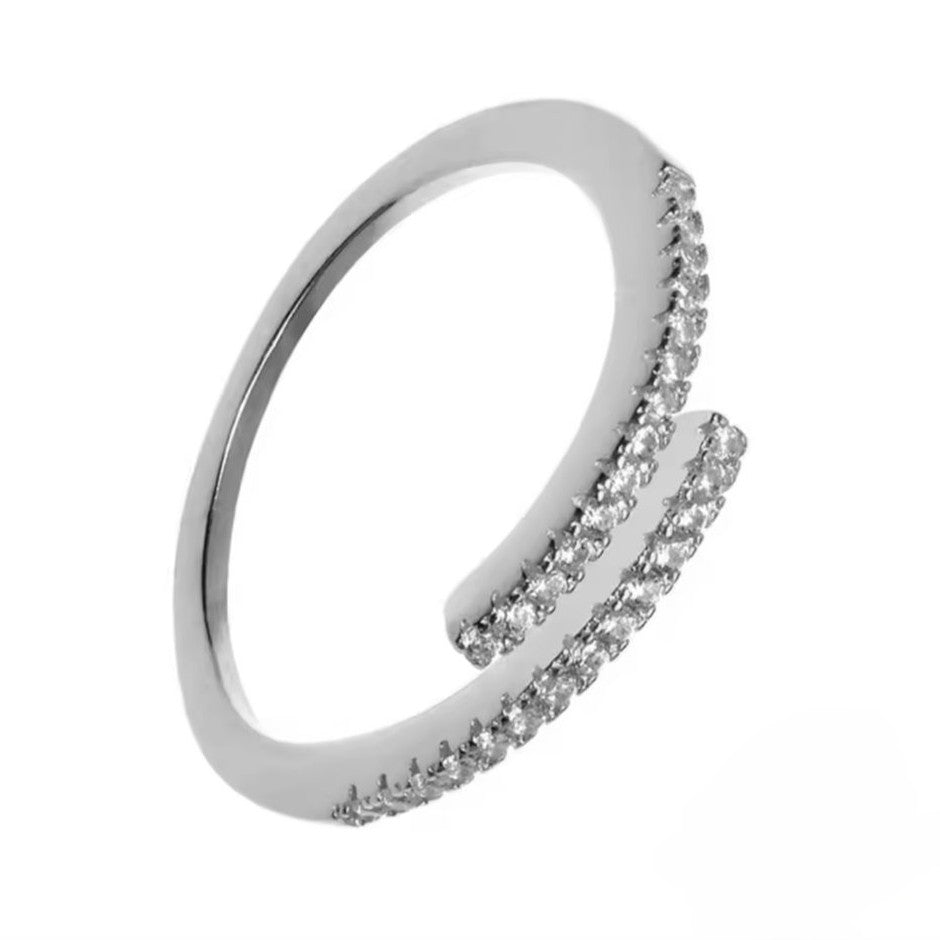 Adjustable silver ring with clear small gemstones on a white background