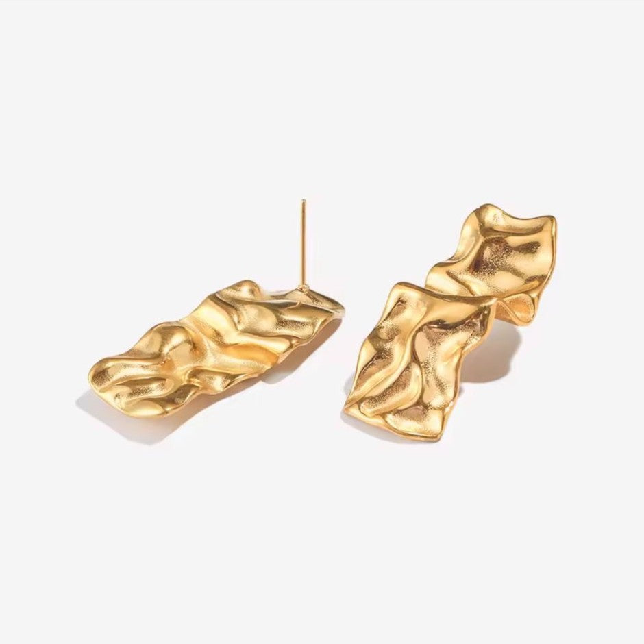 Gold earrings with textured design on a white background