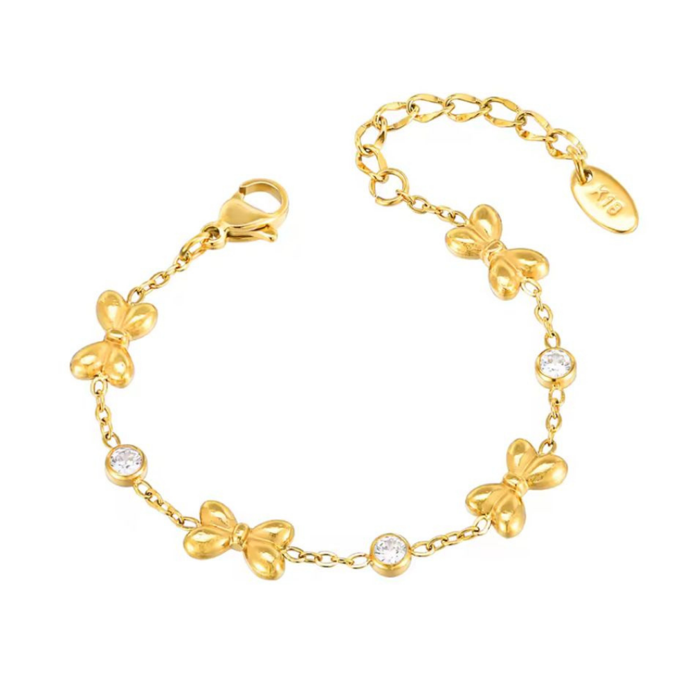 Gold bracelet with butterfly designs and clear stones on a white background