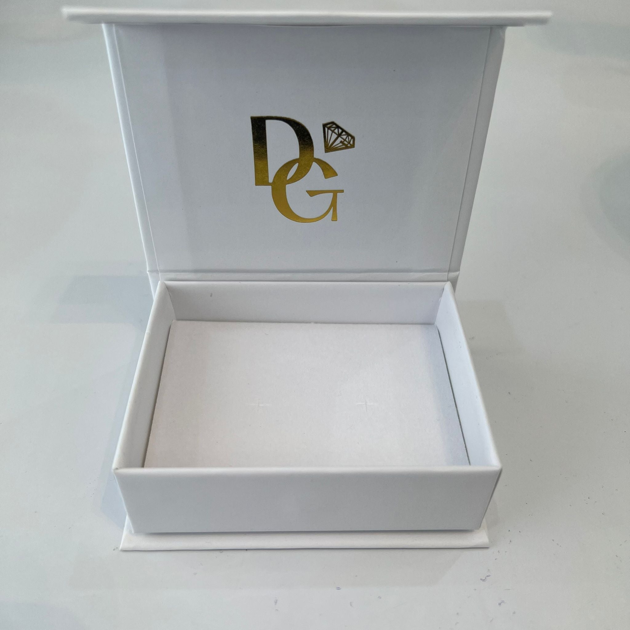 White jewelry box with gold logo on a white background