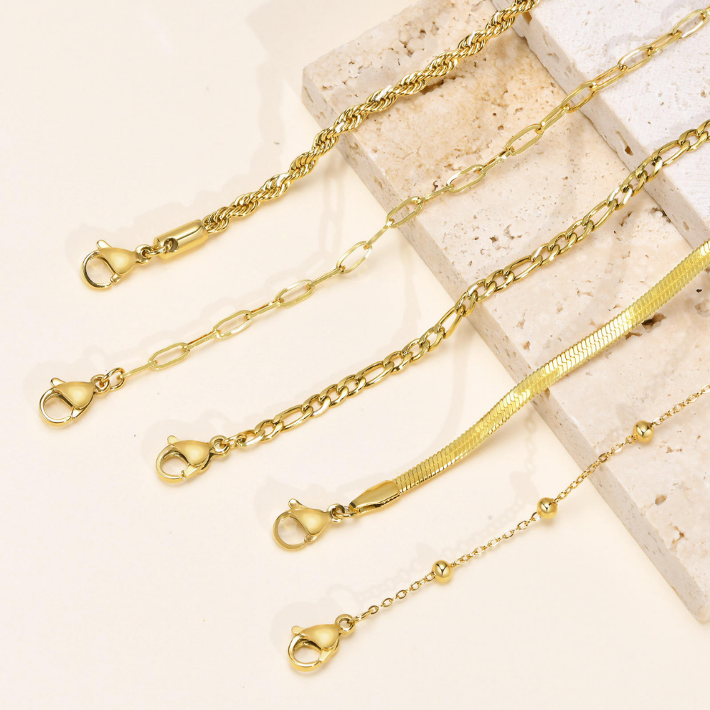Set of 5 Gold Bracelets on a textured stone surface