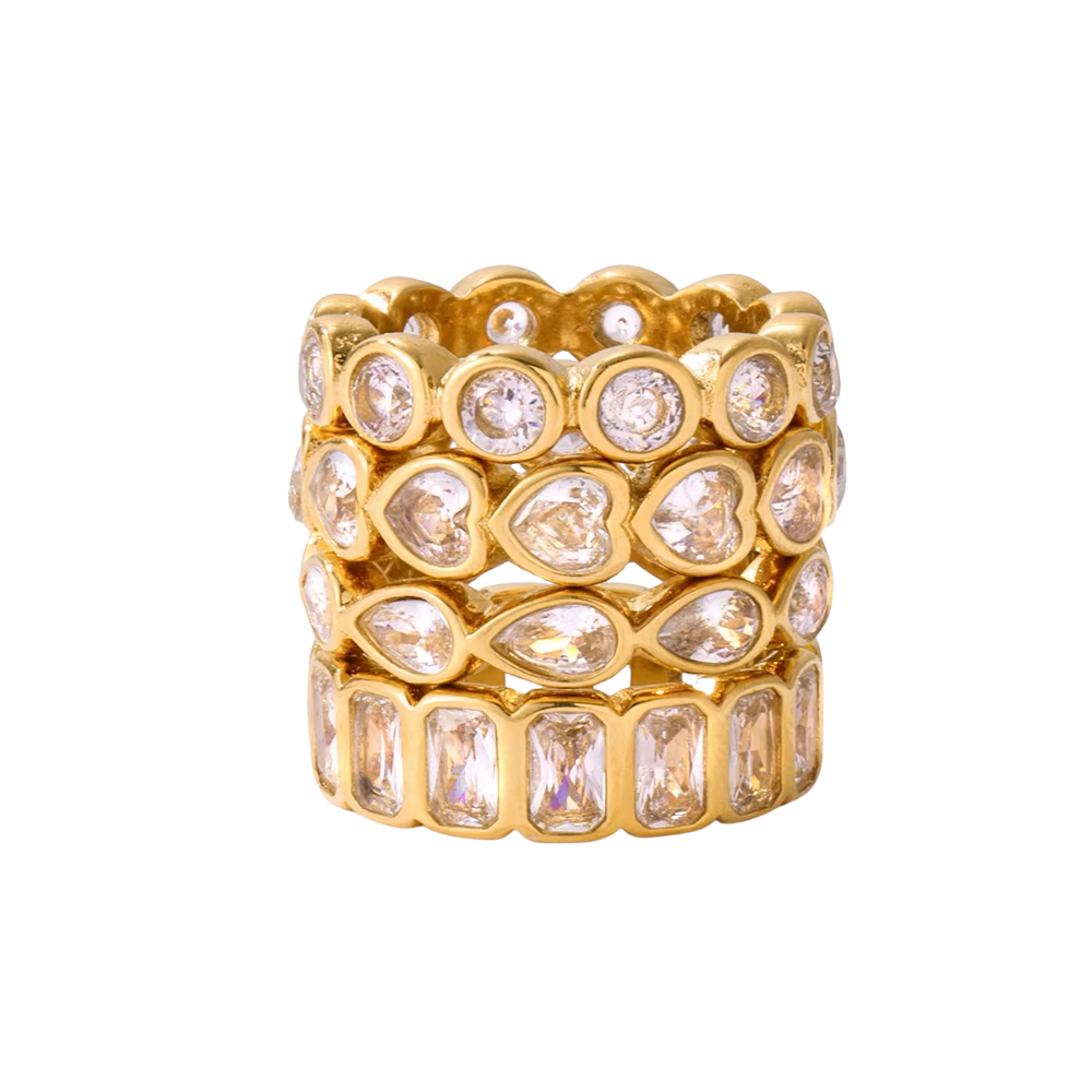 Stack of gold rings with crystal stones on a white background