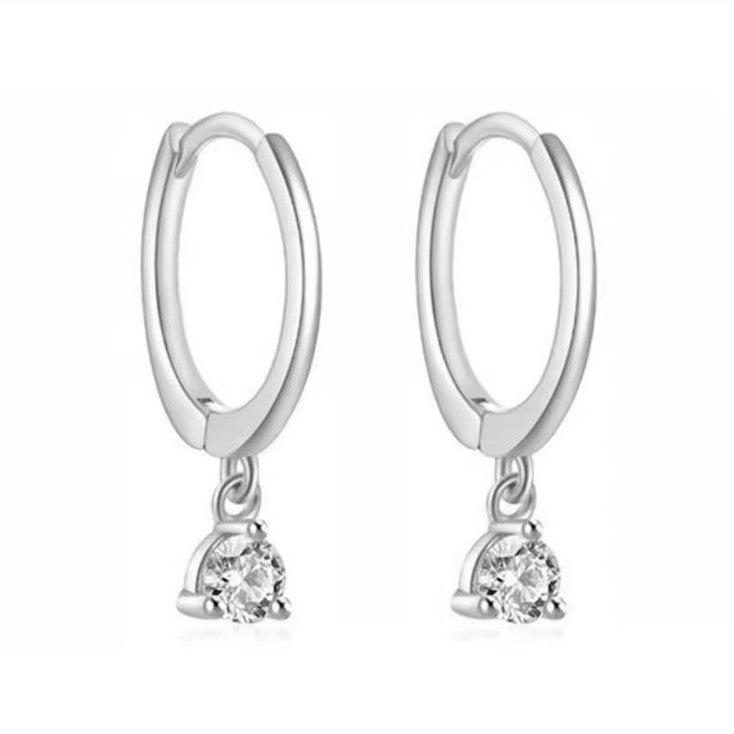 Silver hoop earrings with small round gemstones on a white background