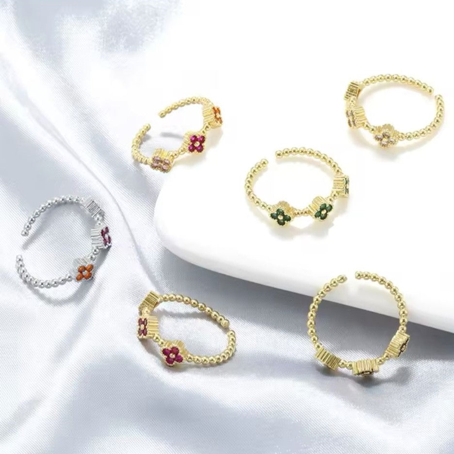 Adjustable rings with clover designs, crafted from silver metal in silver and gold-color displayed against a white background