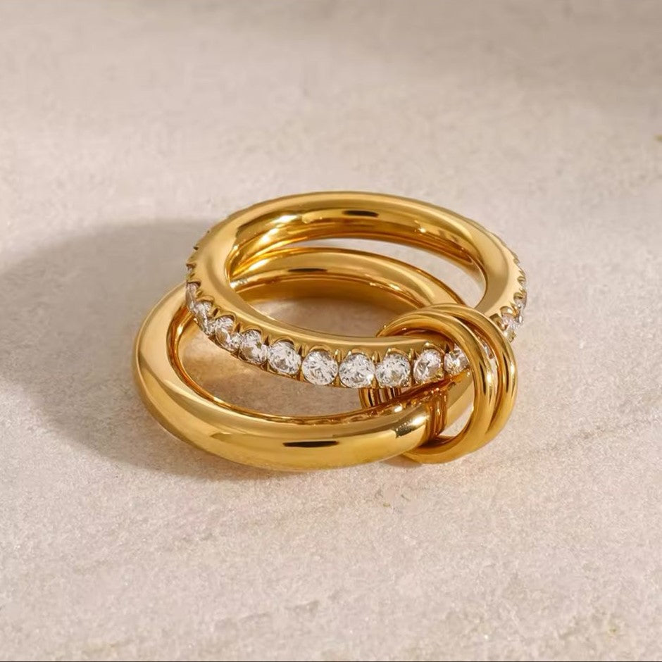 A gold-plated stainless steel double layered ring with the lower band embellished with crystals.
