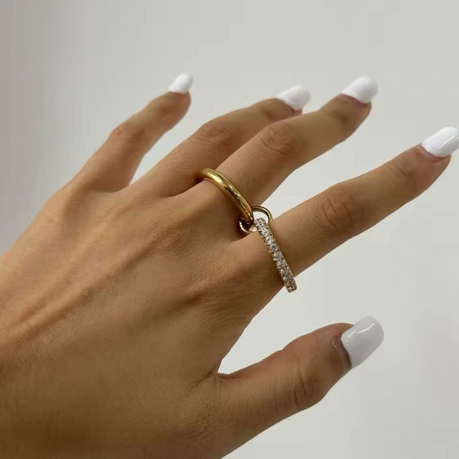 A gold-plated stainless steel double layered ring with the lower band embellished with crystals.