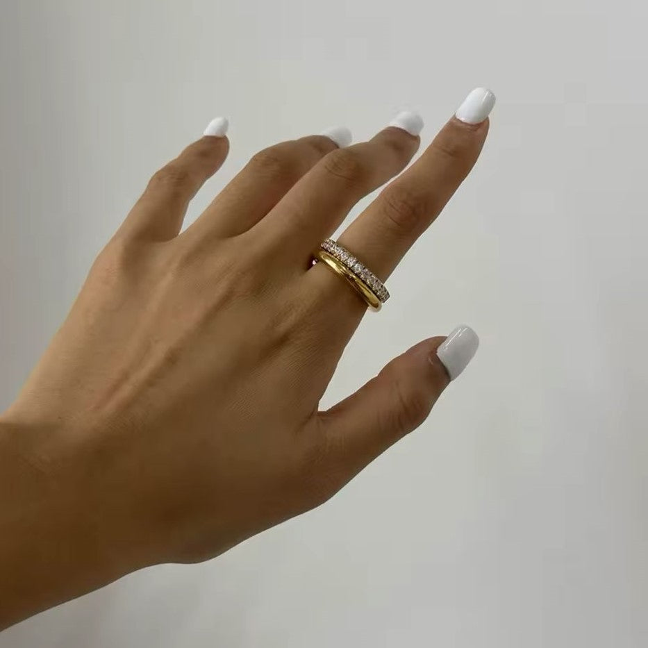 A gold-plated stainless steel double layered ring with the lower band embellished with crystals.