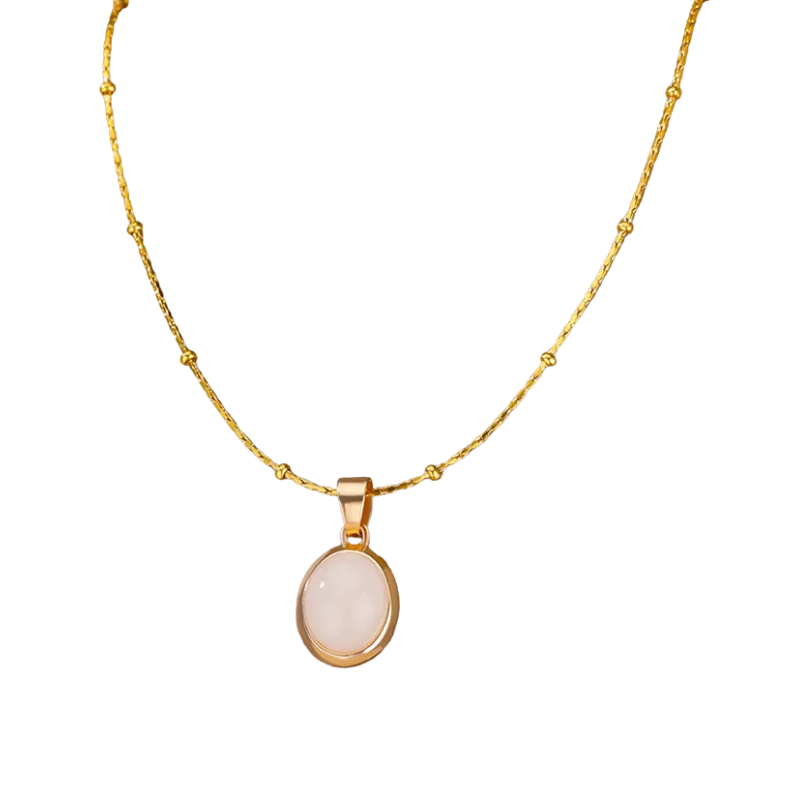 Gold necklace with a white oval pendant on a white background.
