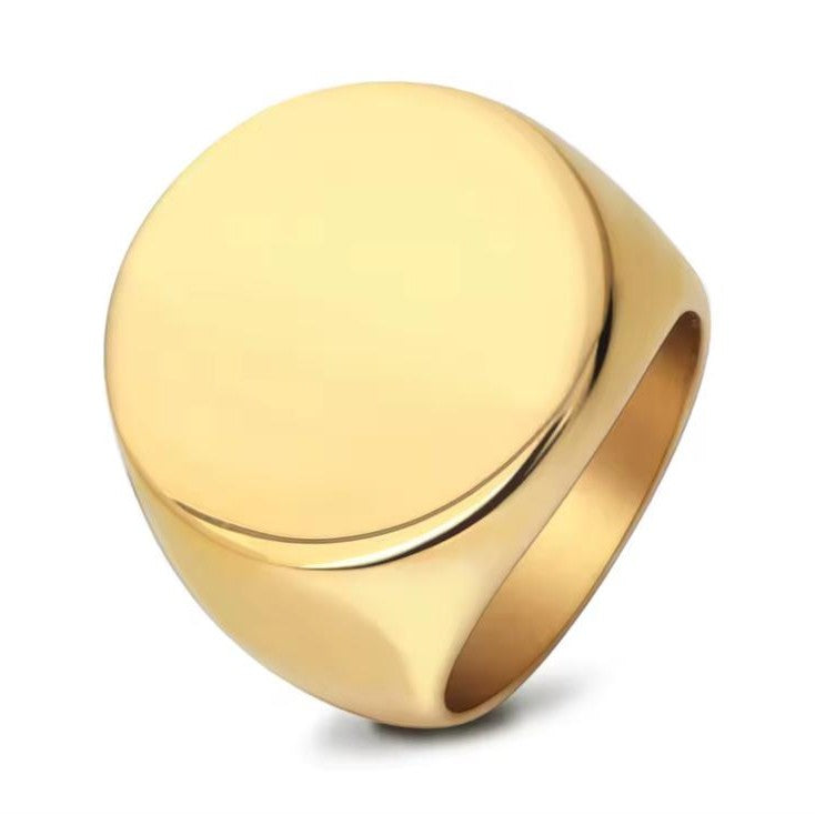 Men's gold engravable signet ring on a white background
