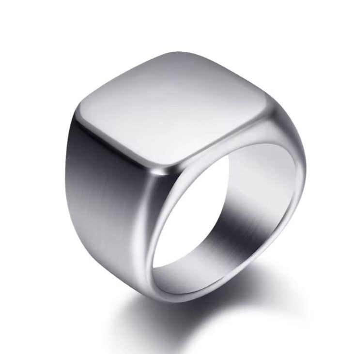 Men's silver engravable signet ring on a white background