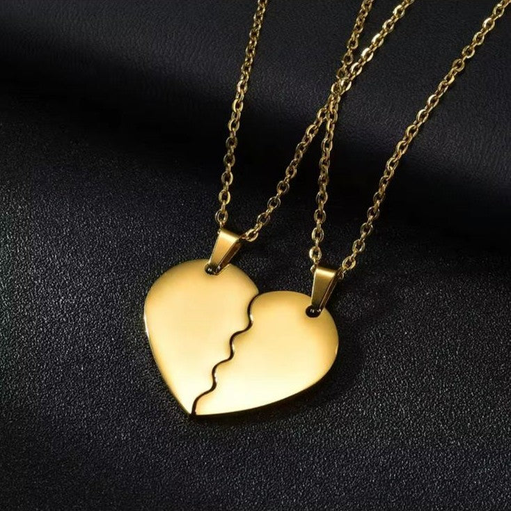 Gold heart-shaped pendant necklace on a dark background