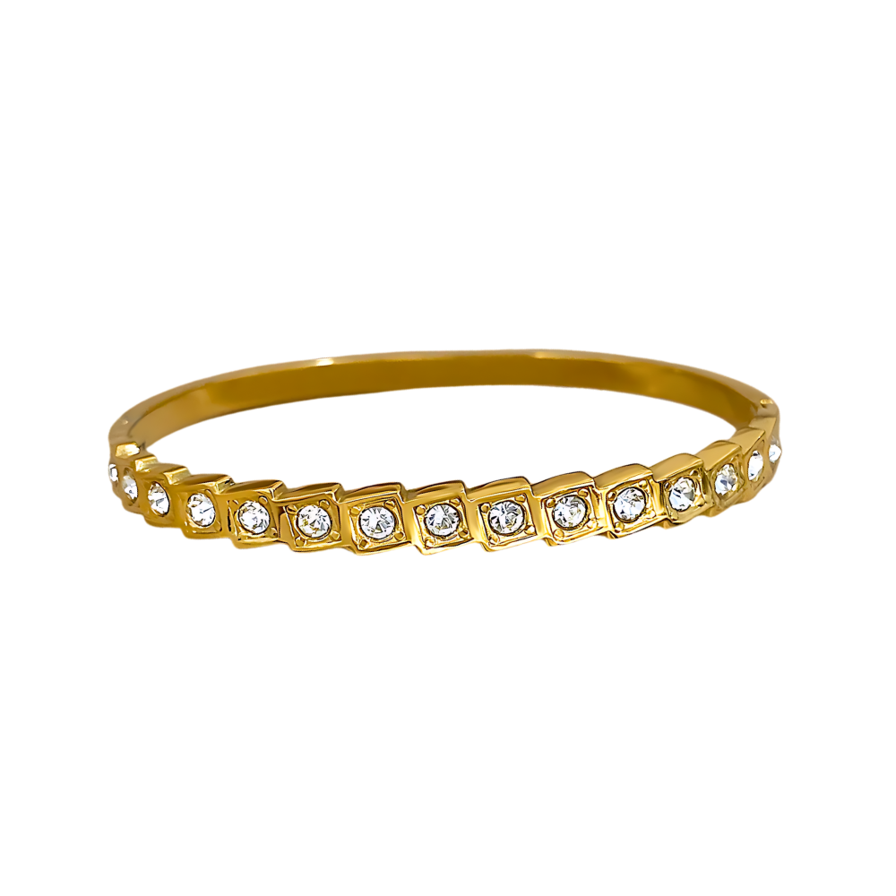 Gold bracelet with embedded crystals displayed on a white background