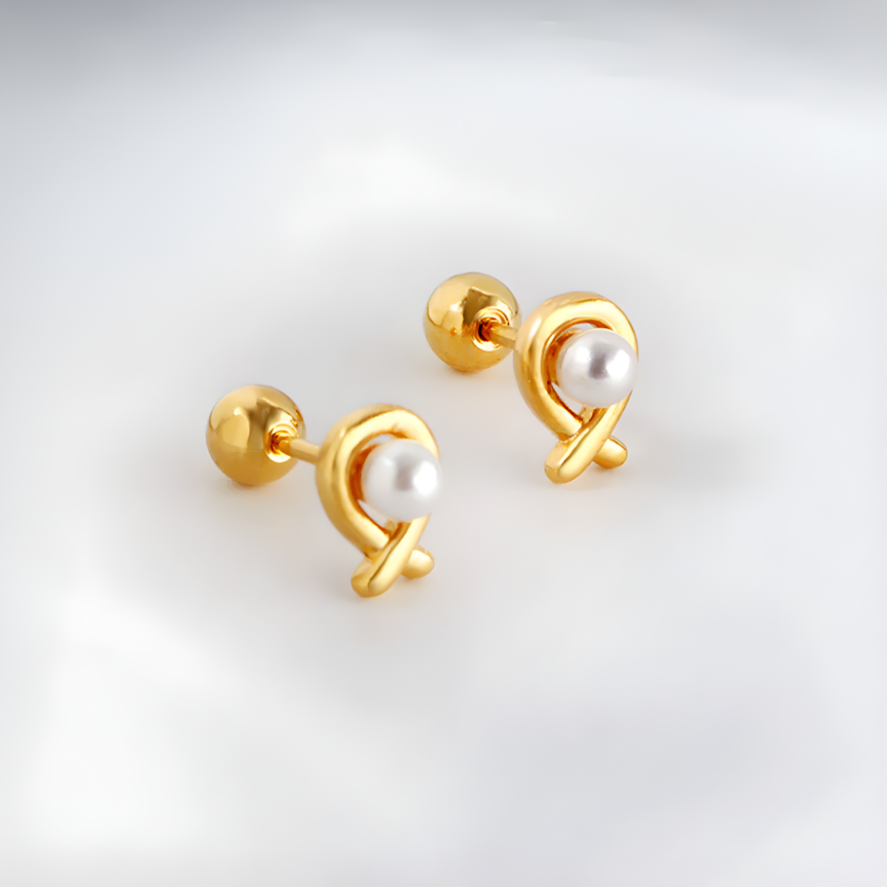 Gold earring with pearl on a neautral background