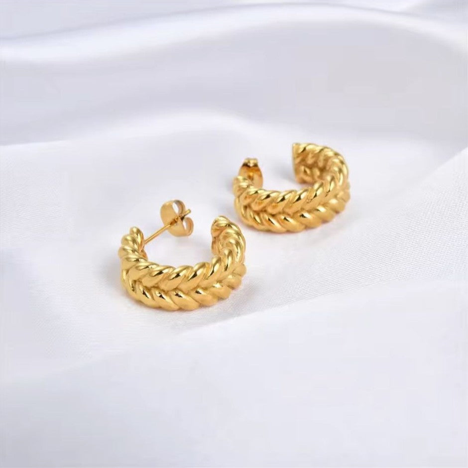 Gold hoop earrings on a white background
