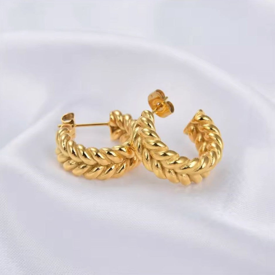 Gold hoop earrings on a white background