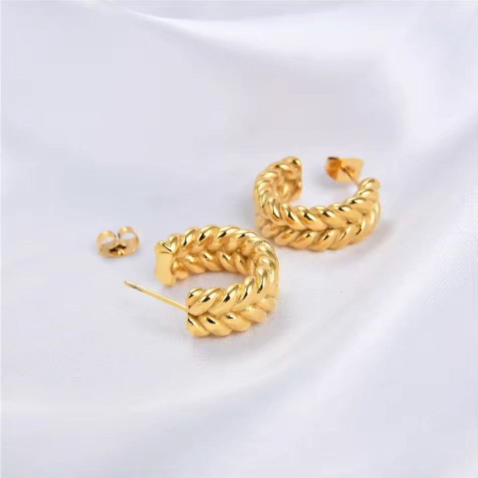 Gold hoop earrings on a white background
