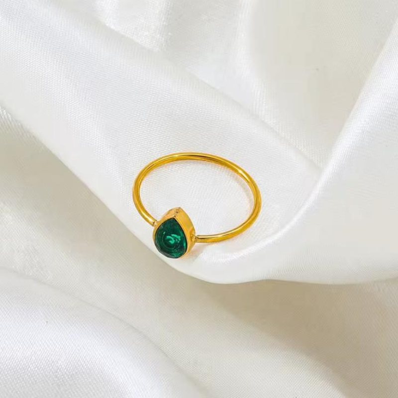 Green teardrop stone gold ring in a refined minimalist design.