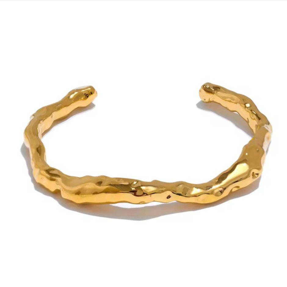 Gold Hammered bracelet on a white background