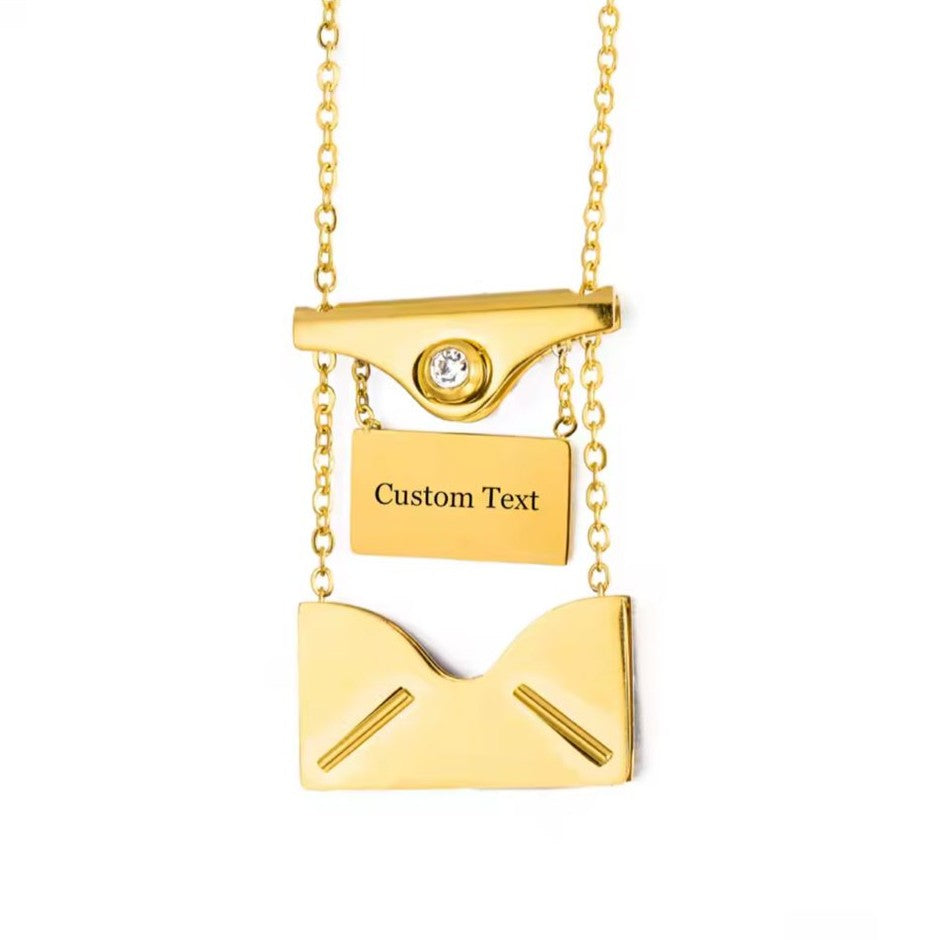 Gold necklace with a customizable pendant on a white background
