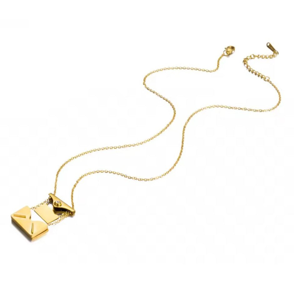 Gold necklace with a envelope pendant on a white background
