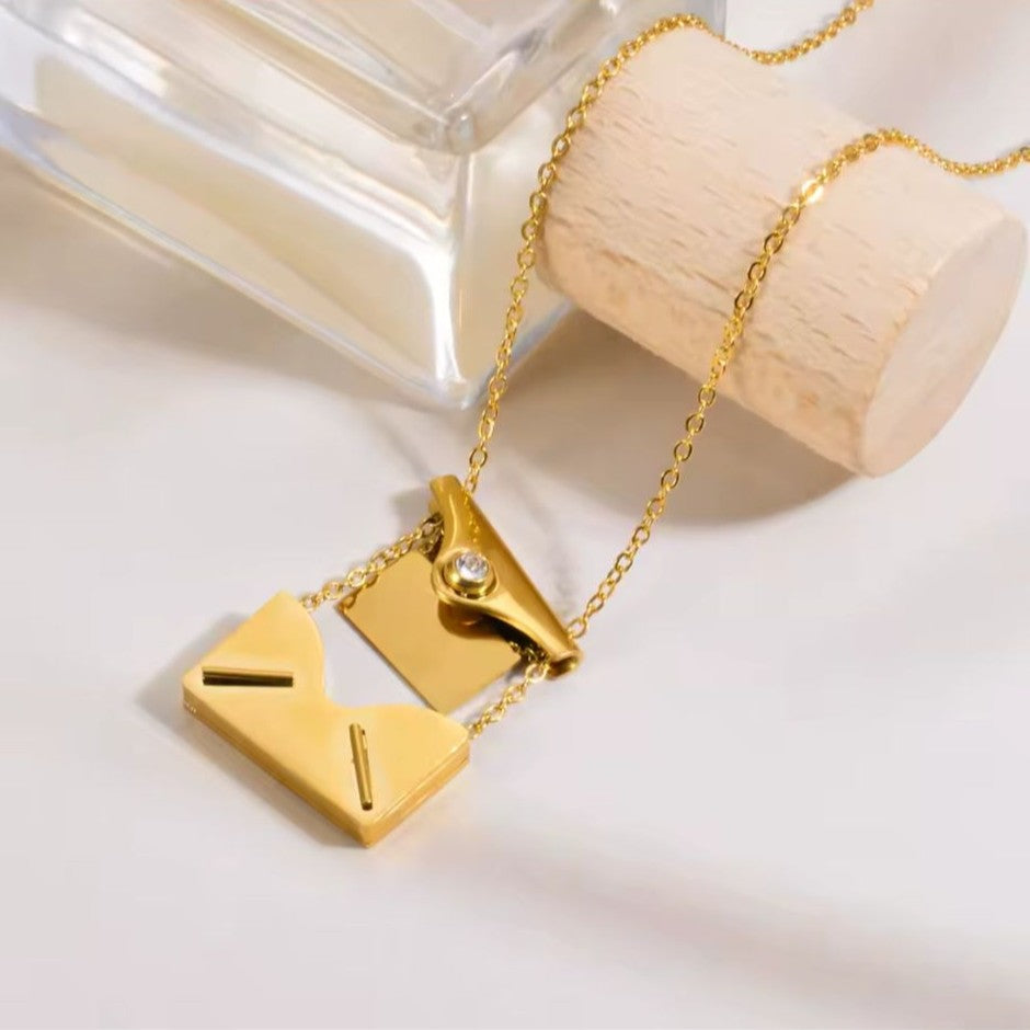Gold necklace with a unique pendant on a light background