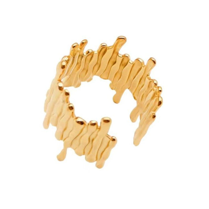 Gold ring with wavy design on a white background