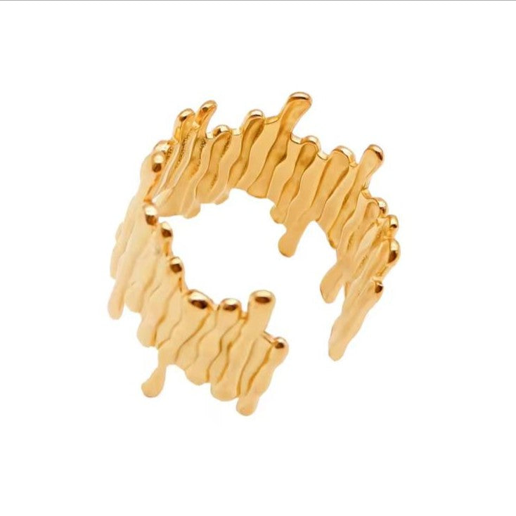 Gold ring with wavy design on a white background