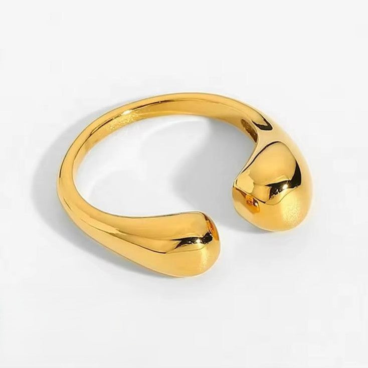 A irregular adjustable gold ring on a white background.